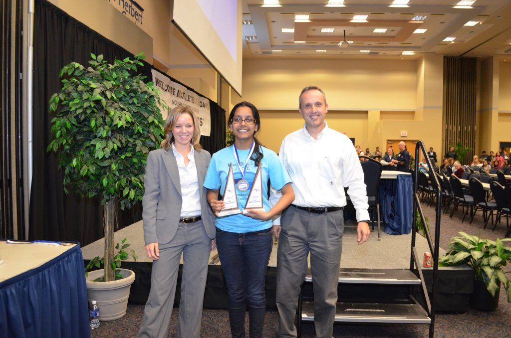 Mathcounts student with trophy. 