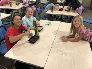 Girl Scouts gathering at lunch. 