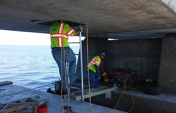 Associate working on bridge. 