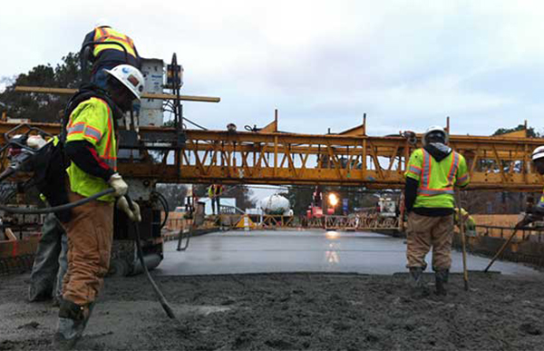 Men paving the 90 bridge. 