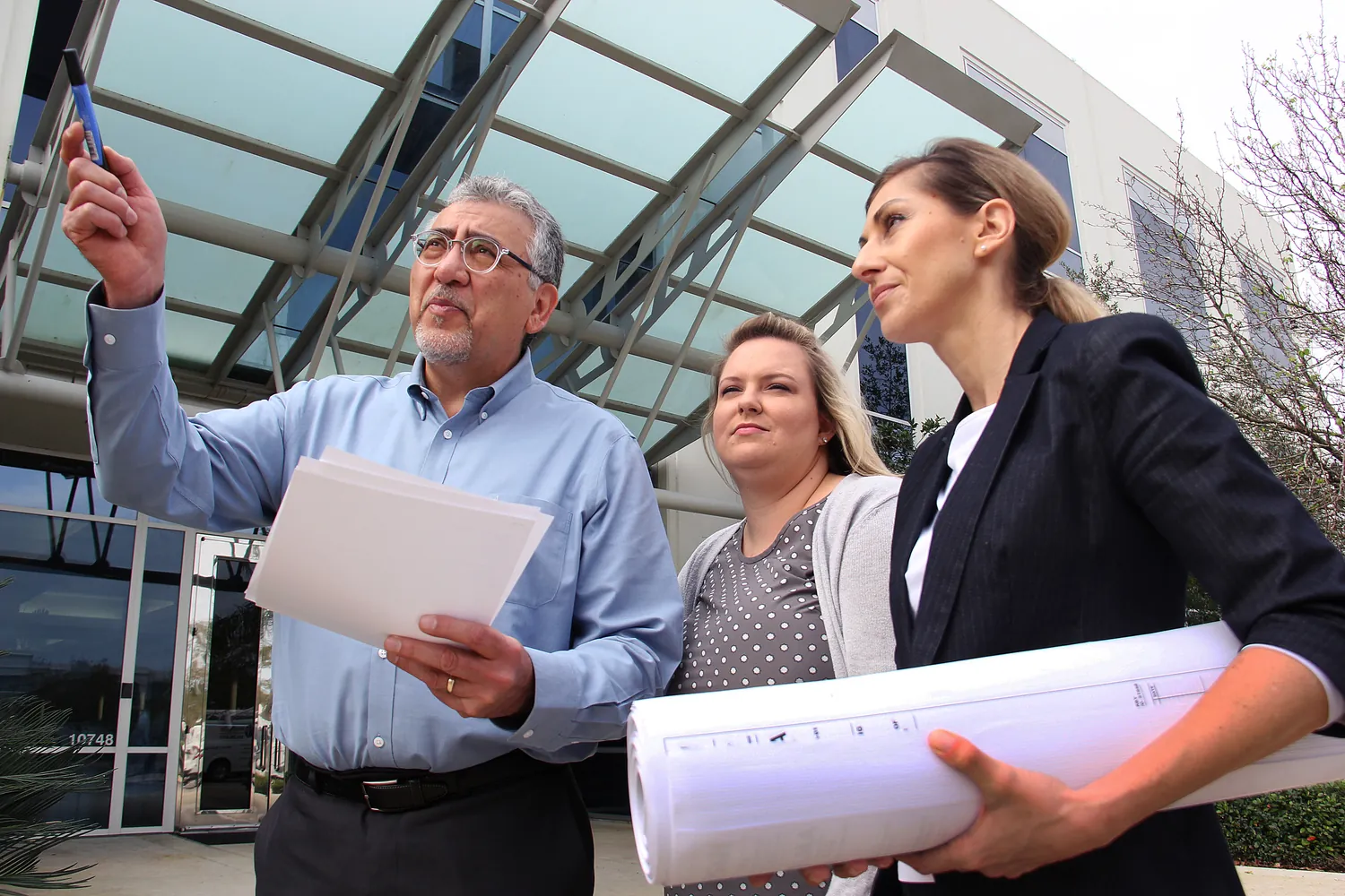 Three associates reviewing project and documents.