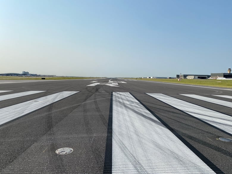 Photo taken of Dallas Fort Worth International Airport Runway 18R-36L standing in the middle of it.