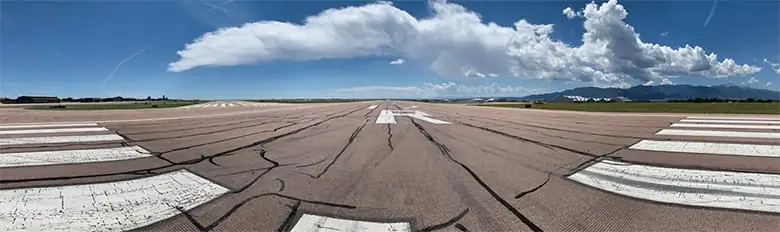 Photo of Colorado Springs airfield before runway rehabilitation showing repairs to cracks.