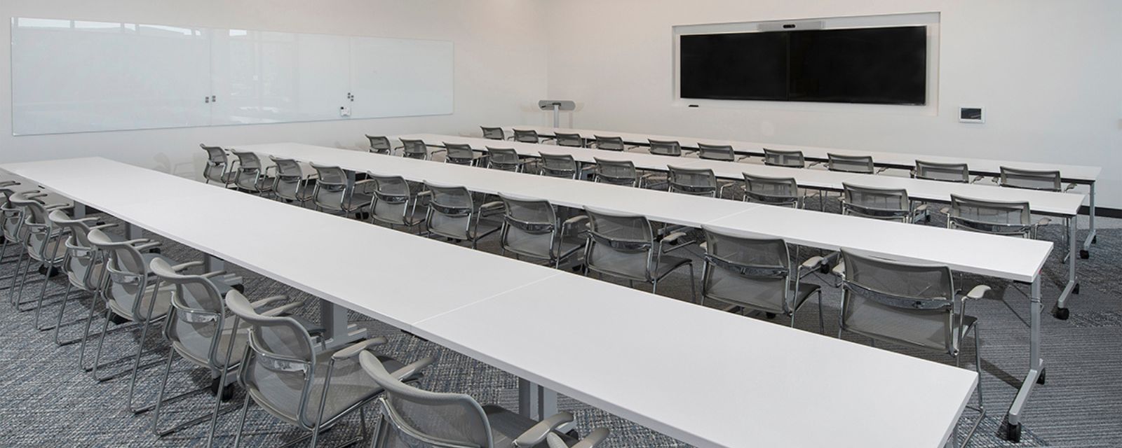 Ridgegate conference room with long white tables.