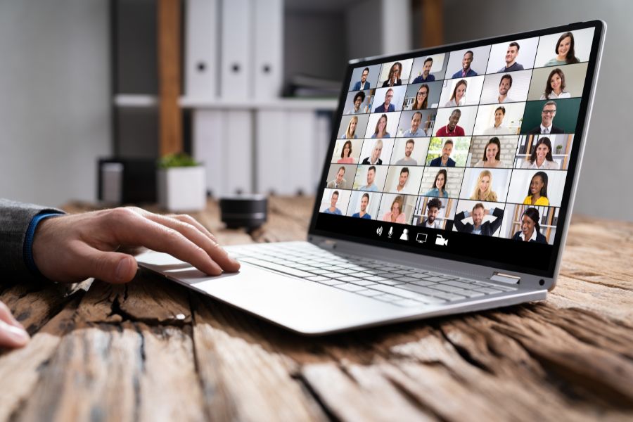 Laptop screen displaying video meeting.