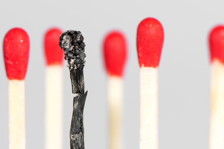 One burned match surrounded by unburned matches.