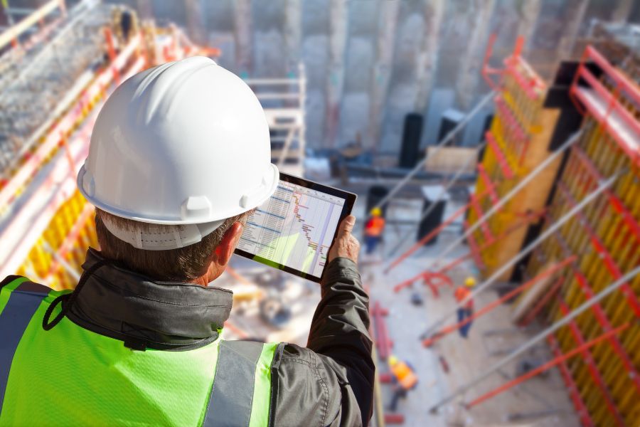 Construction worker looking at iPad.