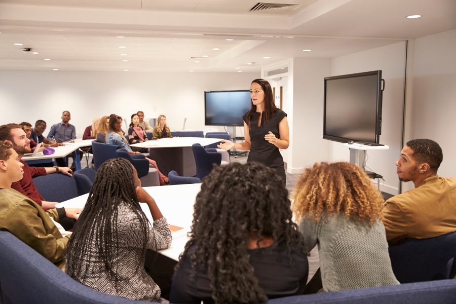 Women presenting to a group of people.