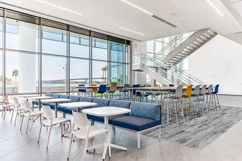 Photo of Brown & Brown break room with modern, comfortable seating and a floor-to-ceiling view of the water.