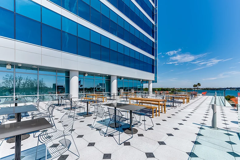 Open-air deck at Brown and Brown headquarters with stylish, modern seating and an unobstructed view of the Halifax River.
