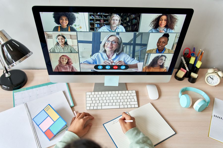 A computer screen with people on a virtual meeting.