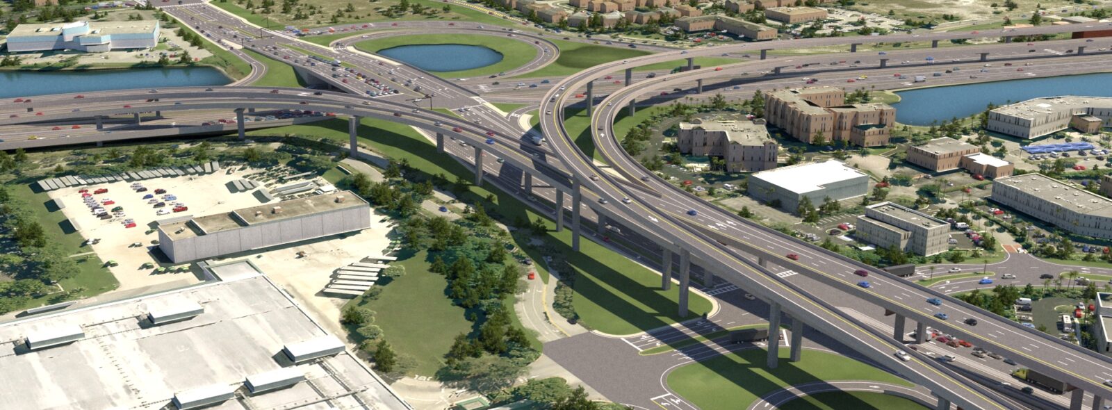 Aerial view of a multi-level highway interchange with surrounding buildings and greenery.