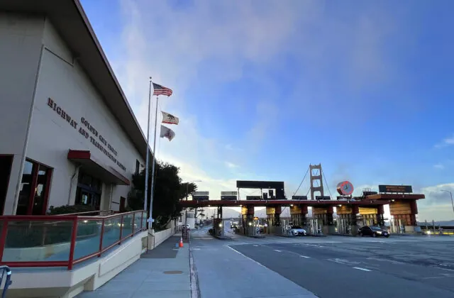 Golden Gate Bridge toll booths and Highway building with flags