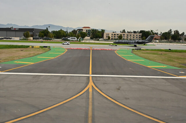 Runway view at Van Nuys Airport with parked jet nearby