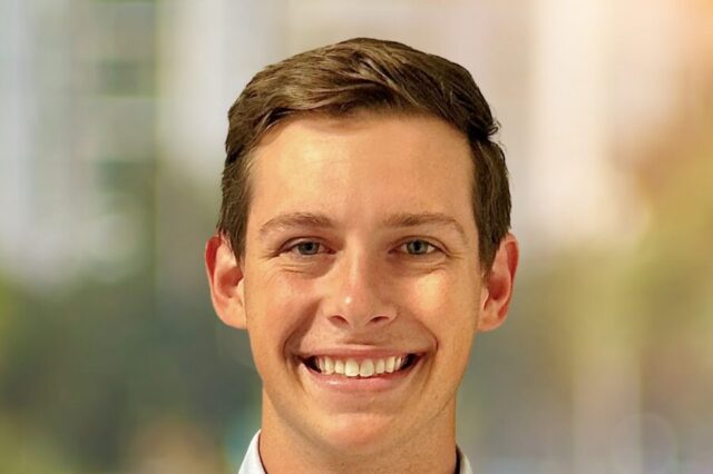 David Bemporad smiling with a blurred outdoor background.
