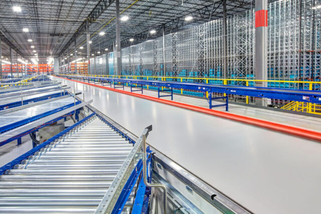 Large industrial warehouse with conveyor belts and shelving units